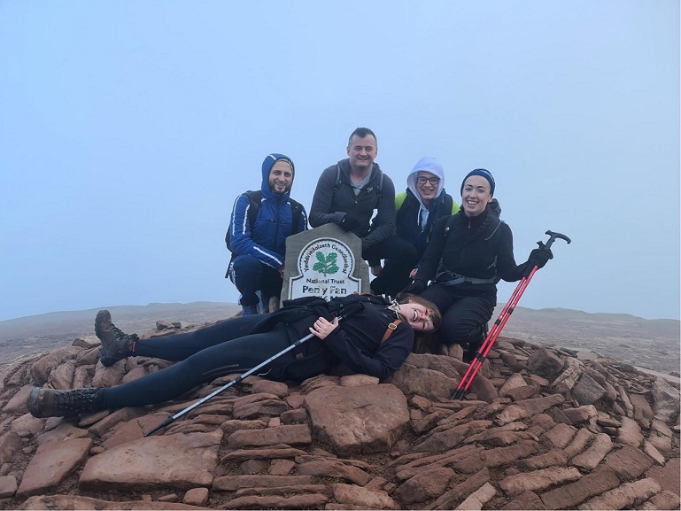 Ascot Group members sat at the top of Pen-Y-Fan, South Wales
