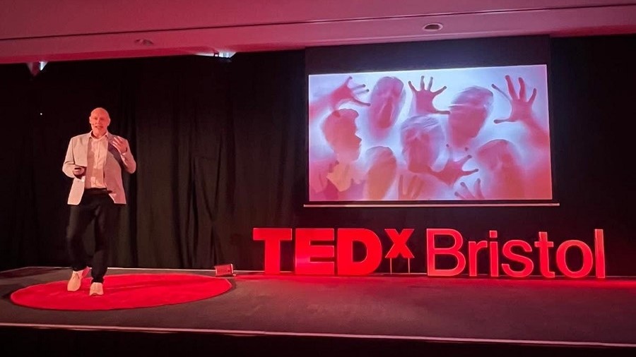 Andrew Scott speaking on the red circle stage at TEDx Bristol.