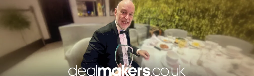 Andrew Scott holding the Guest Speaker of the Year Award at the Dealmaker Awards