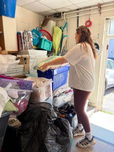 Ascot Group volunteer sorting donated items at Somewhere To Go charity shop in Weston-super-Mare to support the local homelessness charity.